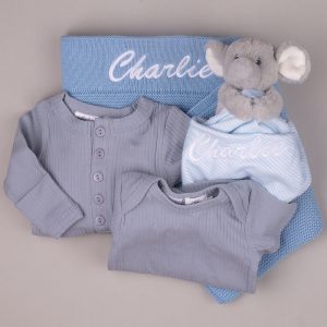 Personalised blue baby blanket with blue ribbed rompers and elephant comforter embroidered “Charlie.”