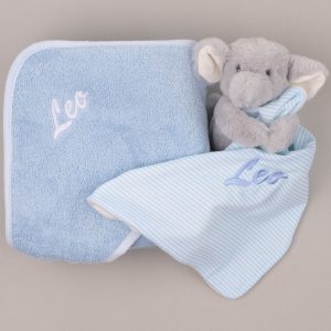 Blue hooded baby towel and elephant comforter embroidered with the name “Leo.”