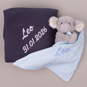 Navy baby wrap with date and elephant comforter, both embroidered with the name “Leo.”