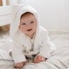 Baby leaning forward & wearing a hooded personalised baby's robe