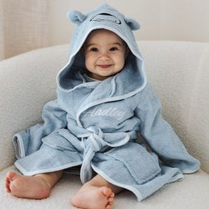 Smiling baby wearing a light blue hooded bathrobe with bear ears & embroidered name "Hadley" on the front.