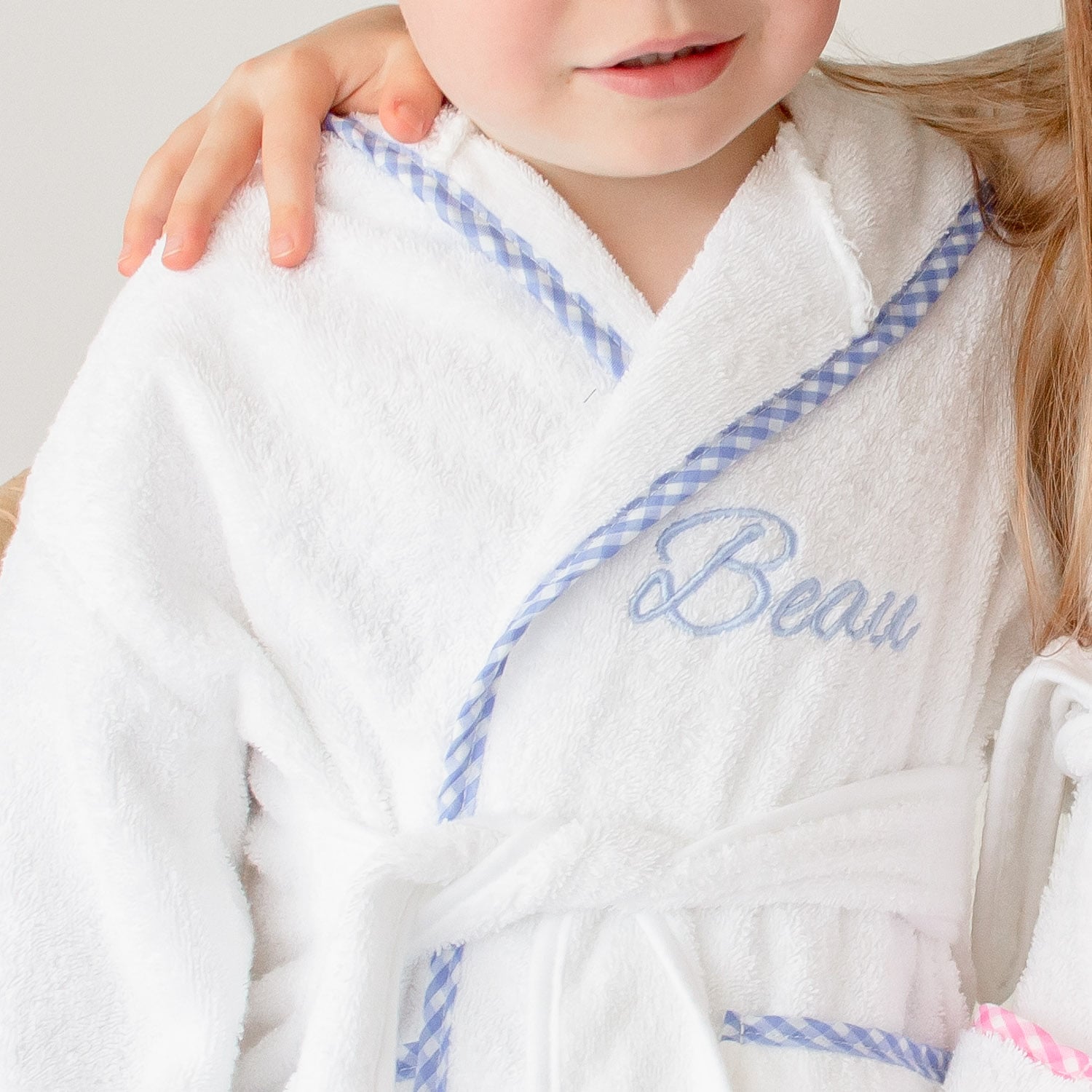 Beau with Blue Gingham Robe close up embroidered with the name Beau.