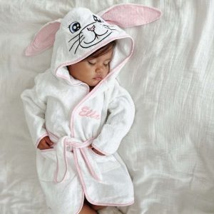 A sleeping baby wearing a bunny personalised robe.