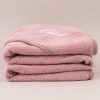 Blush Pink hooded baby towel gift for girls personalised with a baby name and folded.