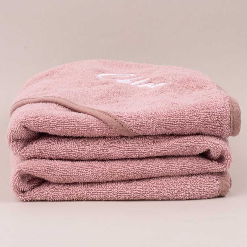 Blush Pink hooded baby towel gift for girls personalised with a baby name and folded.