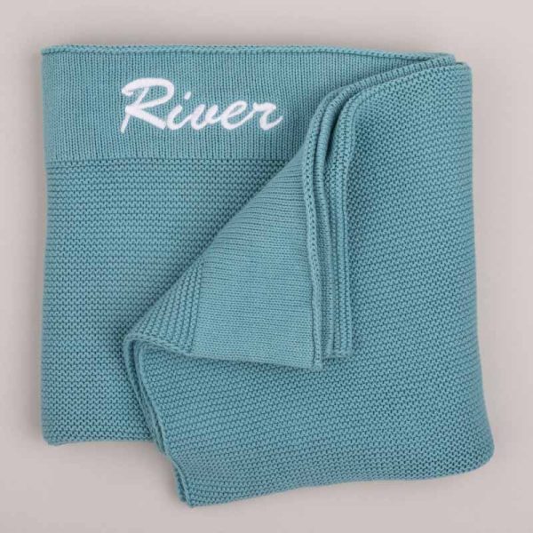 Personalised Ocean Blue Knitted Baby Blanket embroidered with the name River.