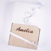 Beige personalised knitted baby blanket with brown embroidered script name presented folded in open One Little Day gift box with white ribbon bow.