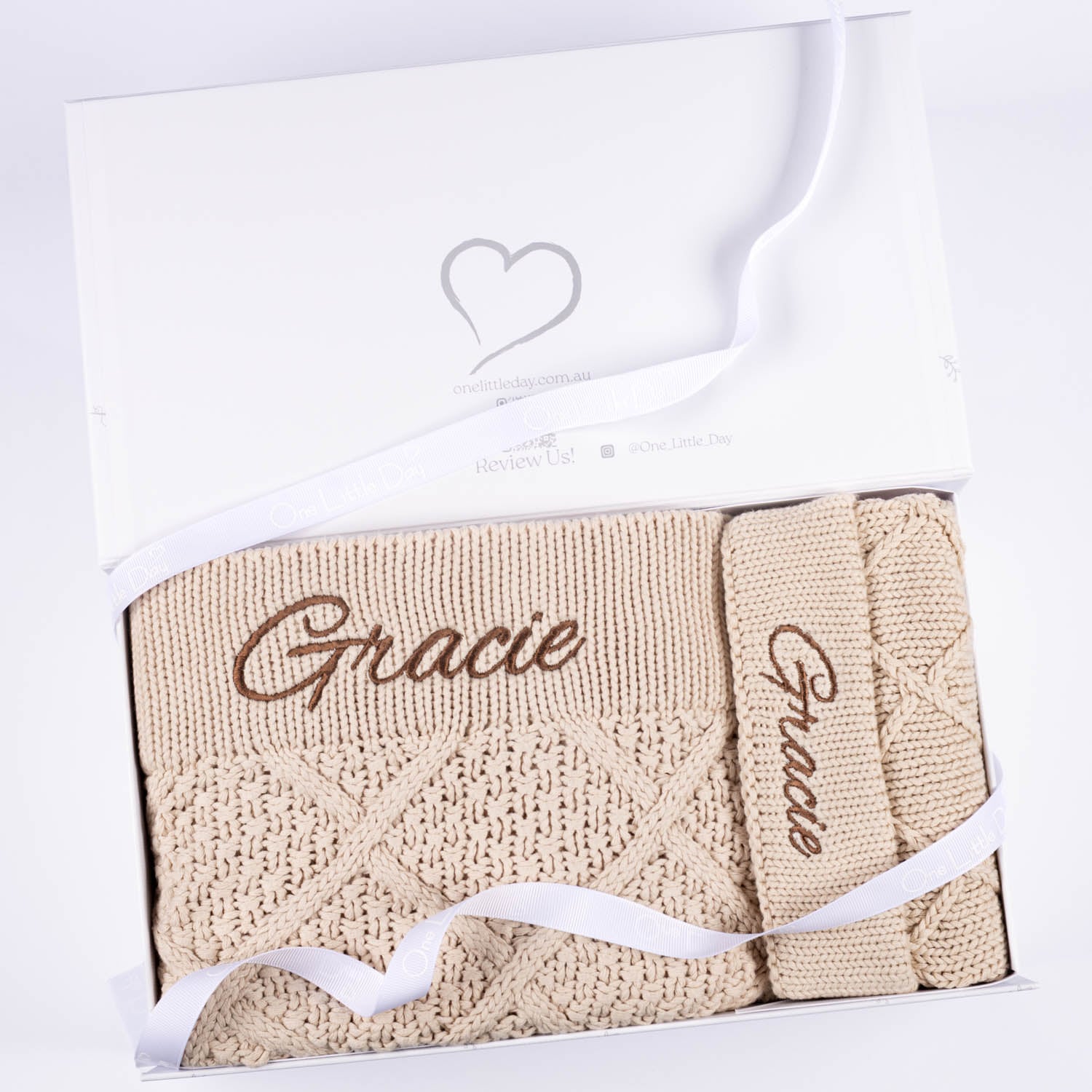Personalised beige diamond knit baby blanket and bear ear beanie gift set presented in a One Little Day white gift box embroidered with the name Gracie