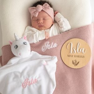 Personalised Blush Pink Blanket, Unicorn and 3D Baby Name Disc with a newborn girl..