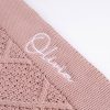 Blush Pink Diamond Knitted Baby Blanket Close Up Close up of white embroidered script name on blush pink cable knit personalised baby blanket showing stitch detail.