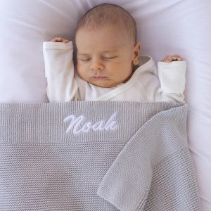 Personalised Light-Grey Baby Blanket Knitted embroidered with boys name Noah.