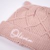 Personalised Blush Pink Diamond Beanie. Close Up Close up of a dusty pink cable knit baby beanie with bear ears showing white embroidered name Olivia