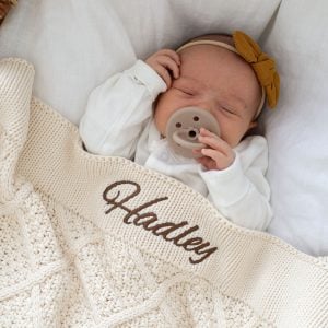 Baby Hadley wrapped in personalised cream diamond knitted blanket newborn gift.