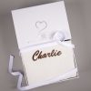 Personalised White Knitted Blanket Gift Box Personalised white knitted blanket embroidered with "Charlie" in brown, tied with white ribbon, presented in a One Little Day gift box.