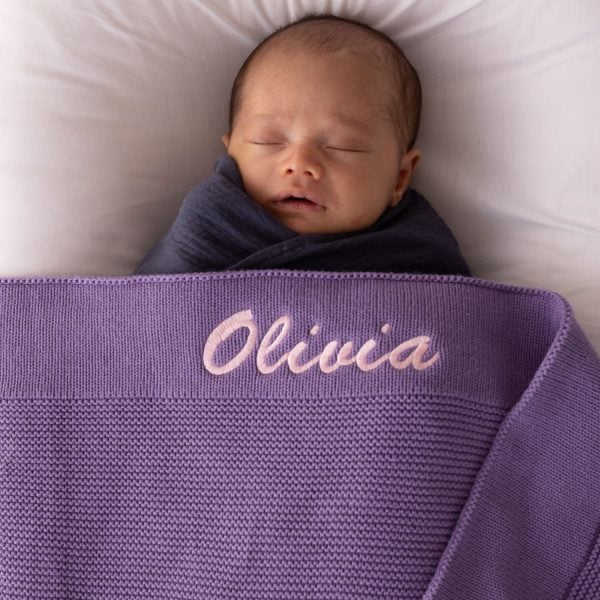 Personalised Purple Knitted Blanket With The Name Olivia Emboridered With Pink Text.. Personalised Purple Knitted Blanket With The Name Olivia Emboridered With Pink Text..
