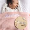 Pink Knitted Baby Blanket & Butterfly Disc Charlotte A baby laying under a pink personalised baby blanket and a birth flowers & butterfly birth announcement disc.