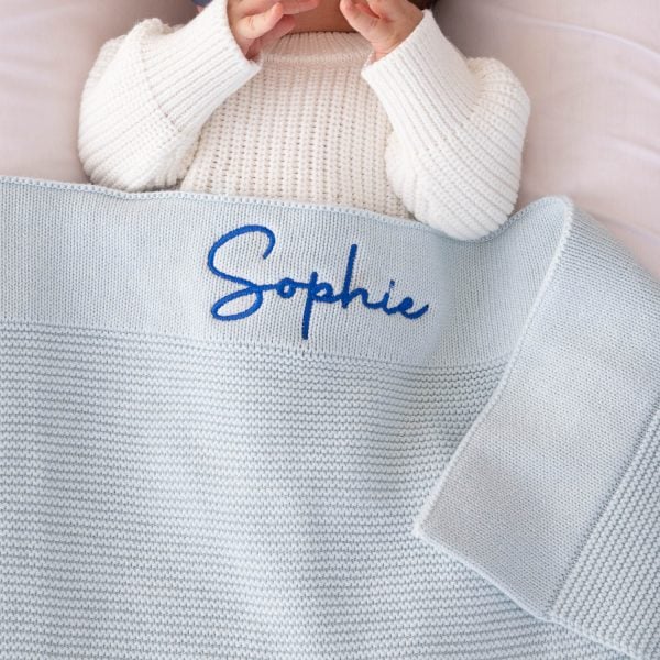 Powder Blue Blanket Embrodiered With The Name Sophie a personalised Powder Blue Blanket embroidered With The Name Sophie in bright blue text.