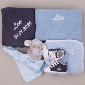 Personalized blue baby gift set with blankets, towel, elephant comforter, and shoes embroidered “Leo” and date.