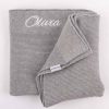 Grey Knitted Baby's Blanket embroidered in white with the name Olivia