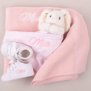 Pink Knitted Blanket, Bunny Comforter & White Baby shoes personalised with the name Mia.