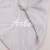 Arlo embroidered with white thread on a grey koala baby comforter.