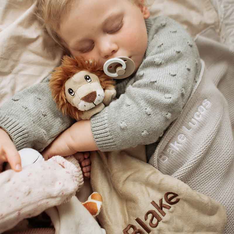 A baby cuddling lion comforter personalised with the name Blake
