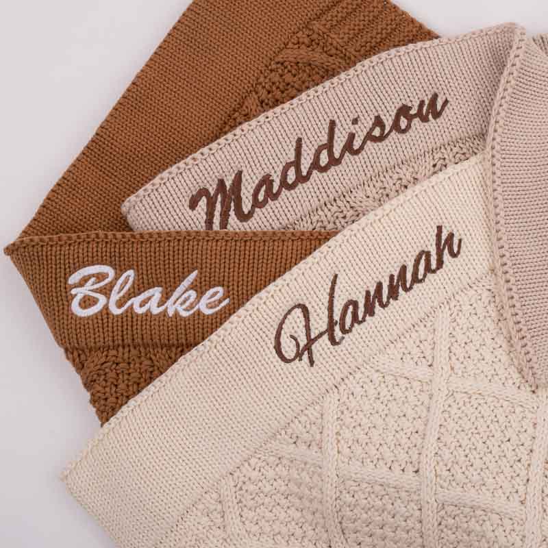 Two diamond knitted baby blankets personalised with name embroidery.