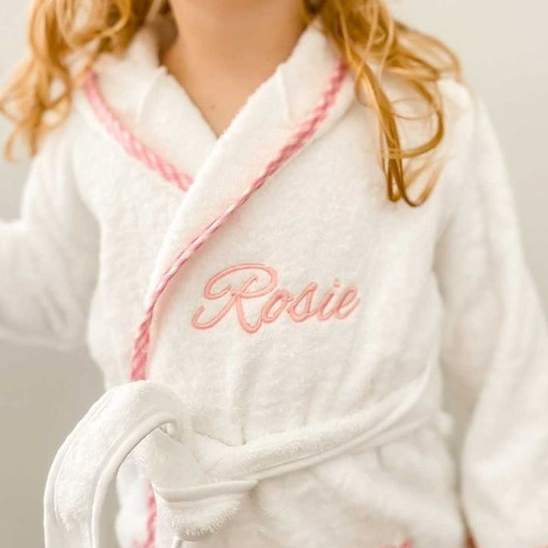 A pink gingham personalised baby robe embroidered with the name Rosie