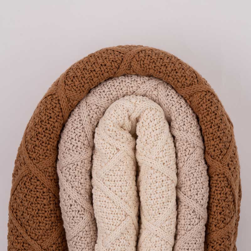 Three diamond knitted blankets folded together