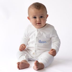 Baby wearing personalised white onesie newborn gift.