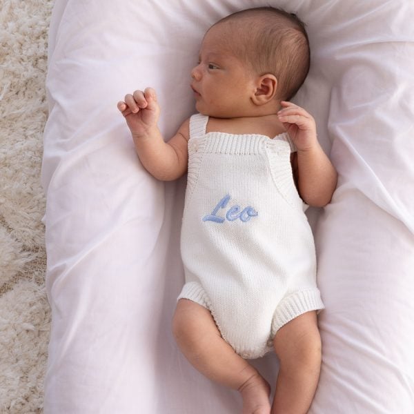 Personalised White Knitted Baby Boy Romper A Personalised White Knitted Baby Boy Romper embroidered with brush script font.