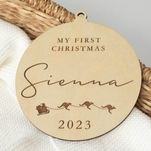 My First Christmas Personalised Disc in basket with white knitted blanket.