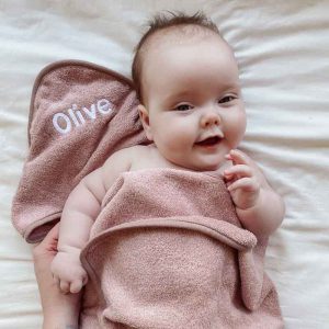 Baby Olive wrapped in personalised blush pink hooded towel unique newborn gift.