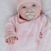 Baby girl wearing personalised pink romper Baby girl wearing personalised pink romper embroidered with Zelie newborn gift.