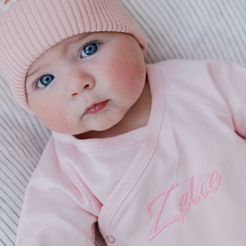 Baby Zelie wearing personalised pink baby romper girl gift.