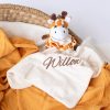 Cute Personalised Giraffe Baby Comforter sitting on a mustard muslin wrap newborn gifts.