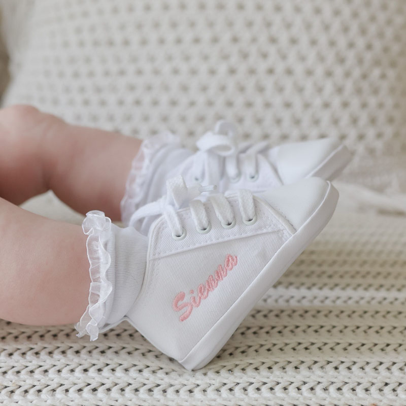 Personalised white pre-walker baby shoes.