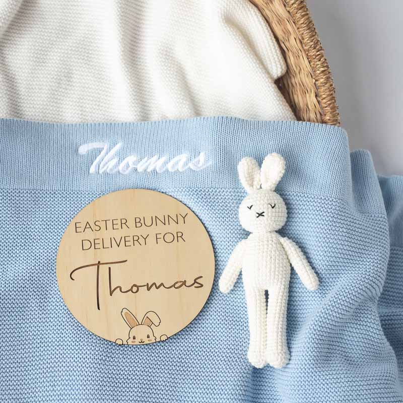 Personalised Easter baby gift including a knitted blanket, bunny rattle and birth disc.