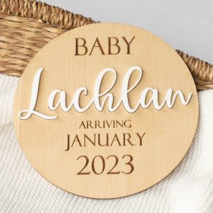 A wood announcement disc with the baby name Lachlan in acrylic, the month of January and year 2023 engraved.