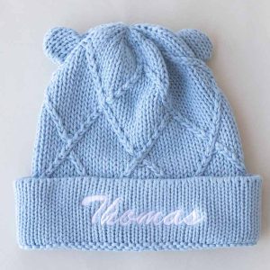 Blue knitted baby beanie with diamond pattern, cute bear ears, & personalised embroidered name.
