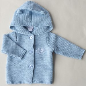 A Blue Hooded Knitted Baby Cardigan embrdoiered with the letter W.
