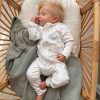 Koala Baby Zip Onesie Reef Sleeping Alternate Newborn sleeping in personalised white koala and eucalyptus print zip romper in rattan bassinet.