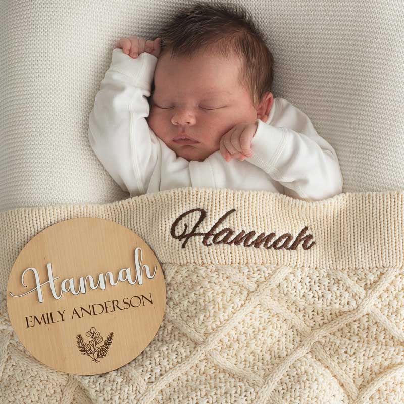 Baby Hannah with personalised cream diamond knitted blanket and birth disc.
