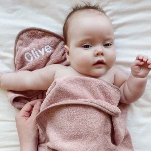 Baby Olive wrapped up in Personalised blush pink towel newborn girl gift.