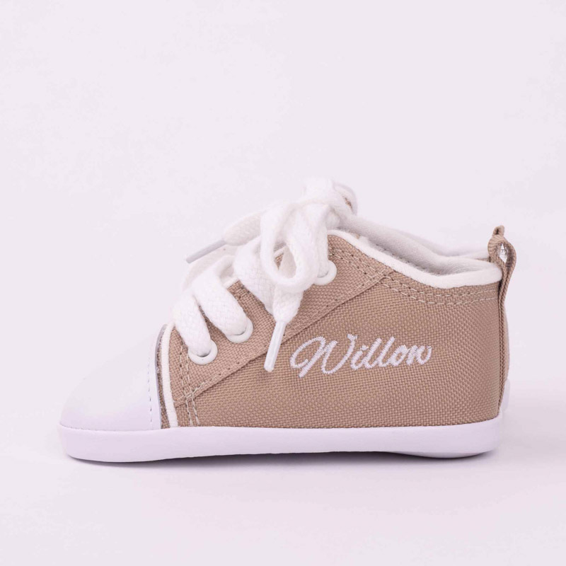 Personalised sand coloured baby shoes embroidered with the girls name Willow.