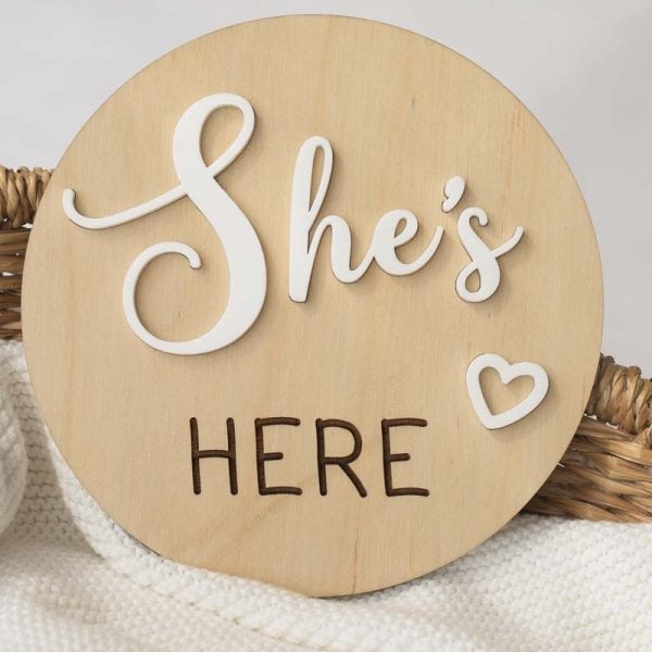 Shes Here Birth Announcement Disc A birth wood birth announcement disc that says "She's Here" with a heart in white acrylic overlayed.