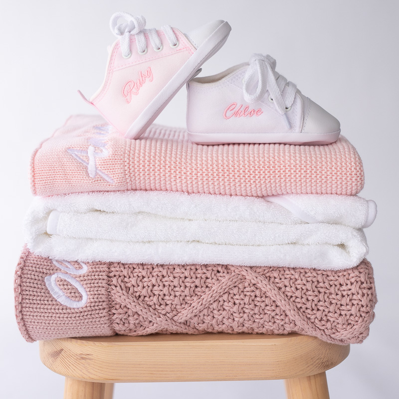 Baby Girl Personalised Gift Ideas knitted blanket, shoes, and towel.