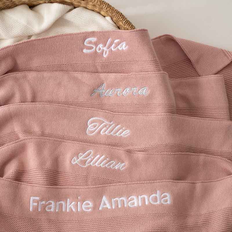 Pink Baby Girl Blanket With Name Embroidery in a basket.
