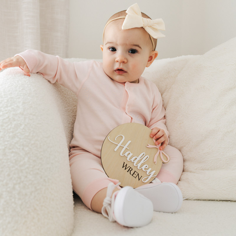 Pink Baby Onesie Shoes And Birth Announcement Disc. personalised with baby name.