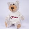Personalised Christmas Teddy & Jumper Olivia Grey plush personalised Christmas teddy bear wearing a white knitted jumper with burgundy embroidered script name on white background.